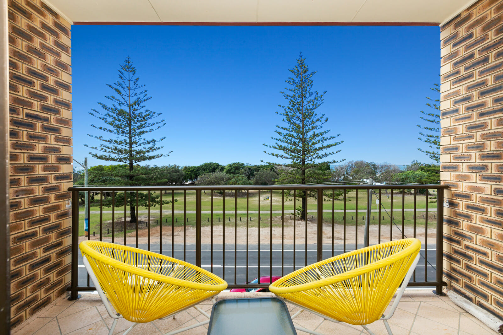 2 sun chairs on patio overlooking oceanfront