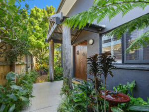Front doors of house with tropical plants beside