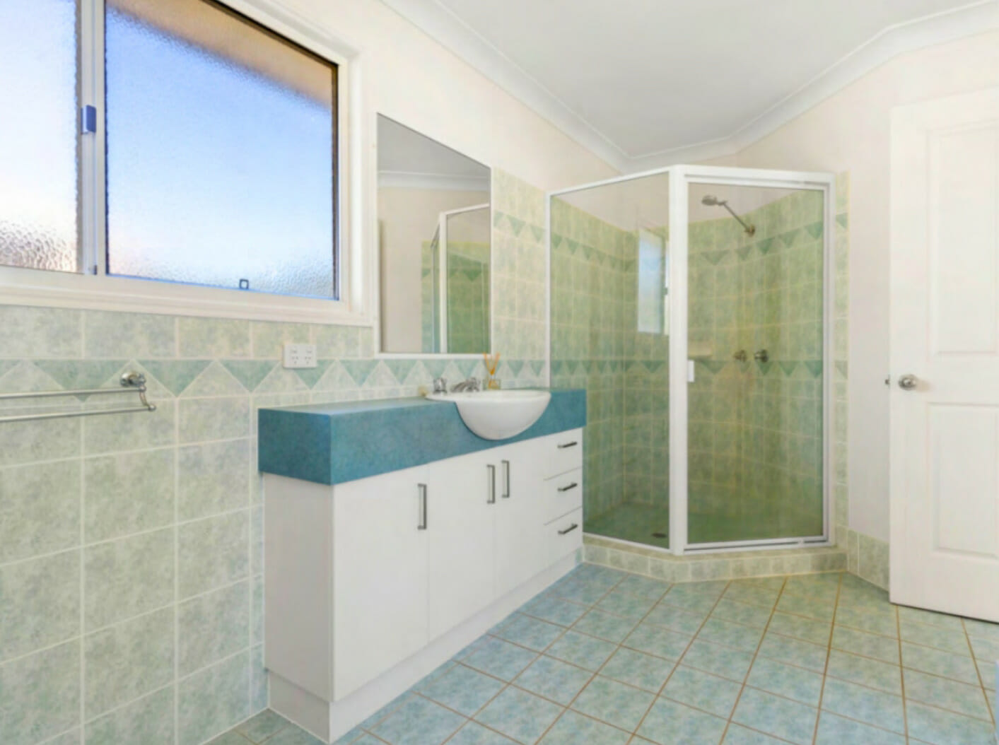 bathroom with glass shower enclosure and vanity basin