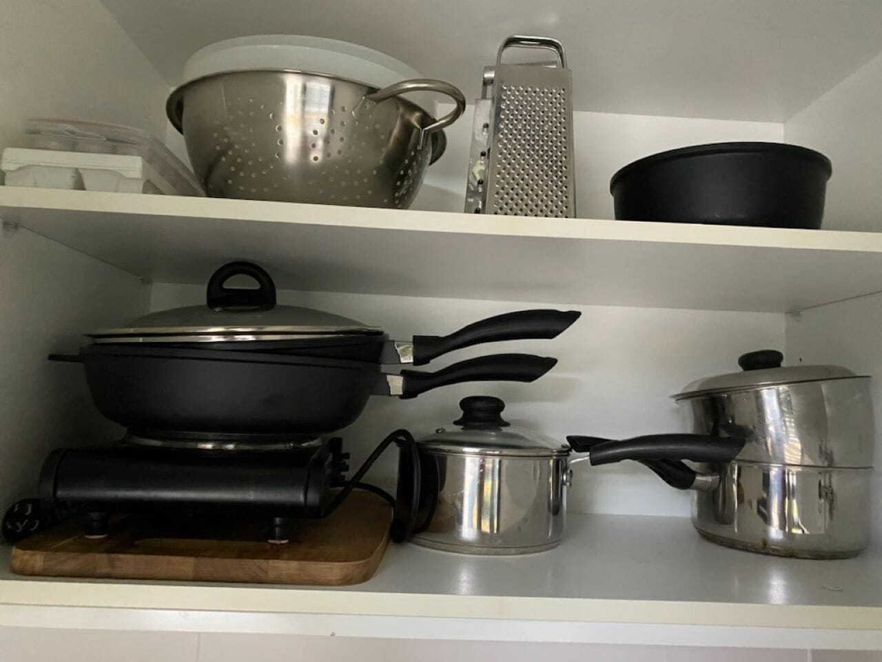 Kitchen cupboard with cookware