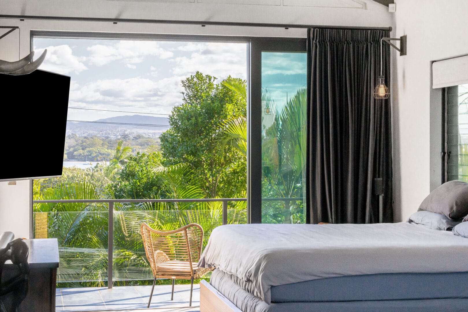 Bedroom with glass doors and mountain view